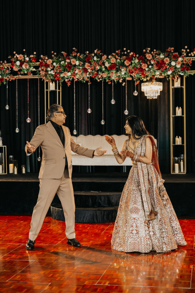 Bride Apoorva dances with her father during wedding reception at Renaissance Depot Minneapolis | Mycah Bain Photography, traditional wedding photographer.