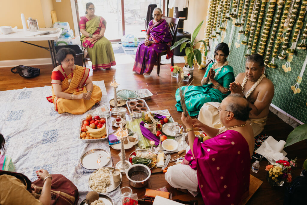 Traditional Indian Var Pooja offerings including fruits, rice, coconuts, and silver vessels arranged for ceremony