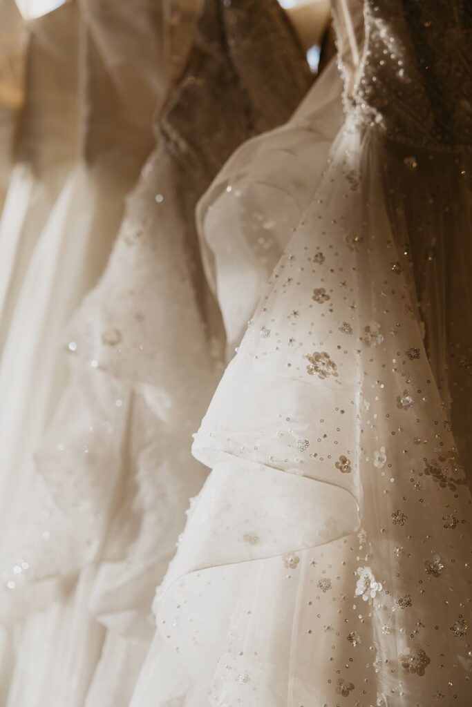 Close-up of shimmering bridal gown with sequin and bead embellishments, part of the Minneapolis bridal gown collection at Vow’d Weddings.