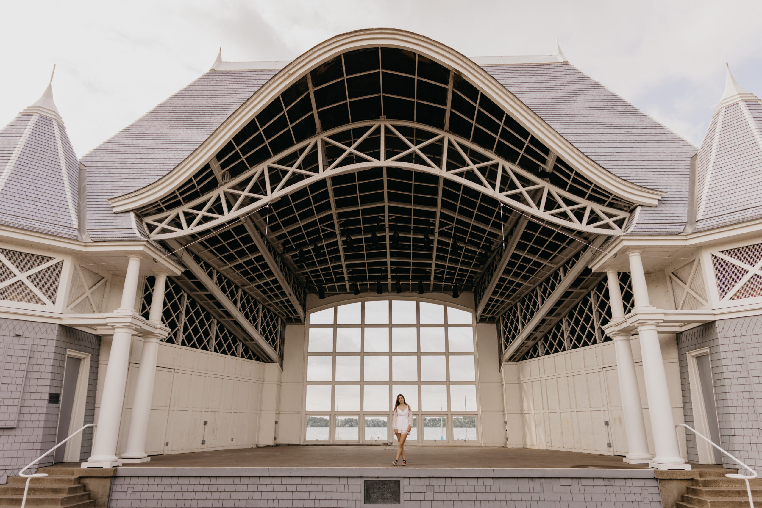 Senior standing at the Lake Harriet Bandshell in Minneapolis during a portrait session.