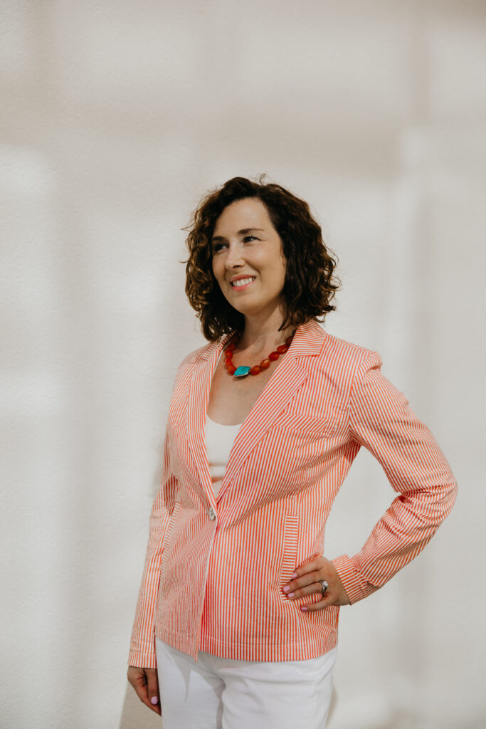 Anne Deanovic laughs during her Edina brand photography session near 50th & France, captured by Minneapolis brand photographer Mycah Bain.