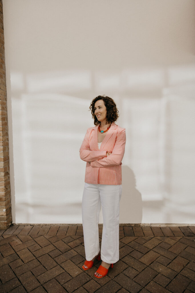 Anne Deanovic laughs during her Edina brand photography session near 50th & France, captured by Minneapolis brand photographer Mycah Bain.
