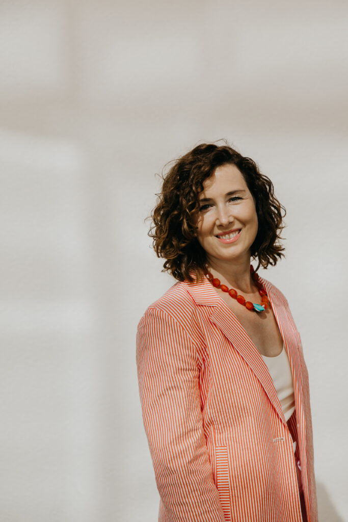 Anne Deanovic laughs during her Edina brand photography session near 50th & France, captured by Minneapolis brand photographer Mycah Bain.