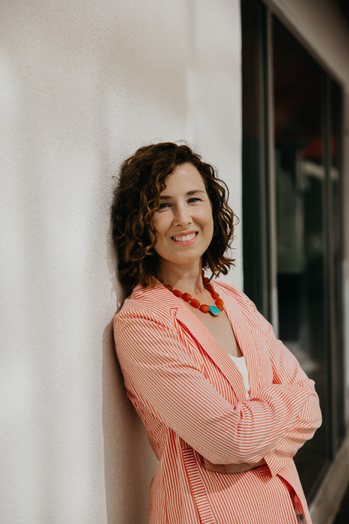 Anne Deanovic laughs during her Edina brand photography session near 50th & France, captured by Minneapolis brand photographer Mycah Bain.