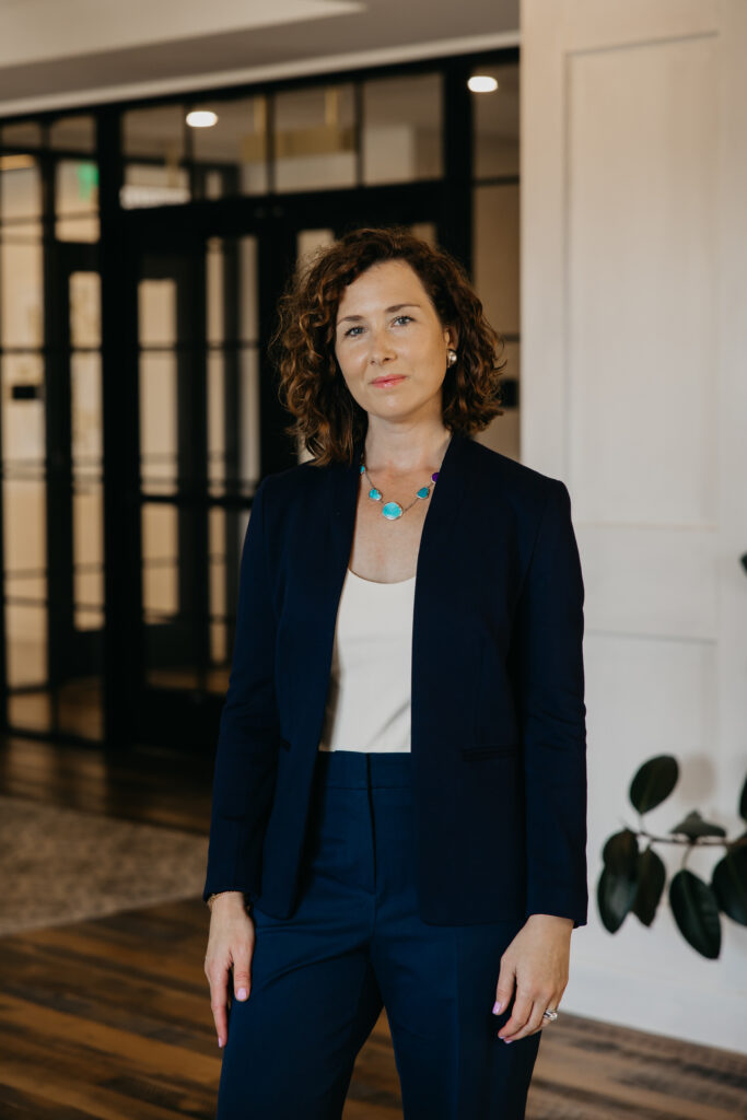 Anne Deanovic, founder of Hot Mustard PR, poses in a modern indoor space near 50th and France for her Edina brand photography session with Mycah Bain Photography.