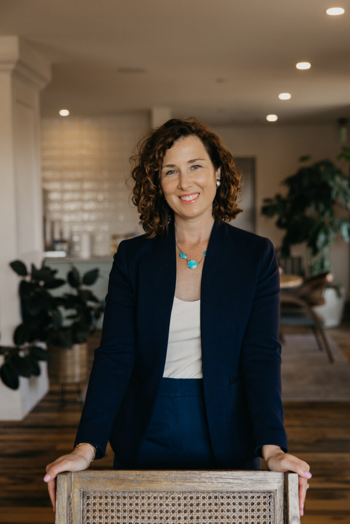 Anne Deanovic, founder of Hot Mustard PR, poses in a modern indoor space near 50th and France for her Edina brand photography session with Mycah Bain Photography.