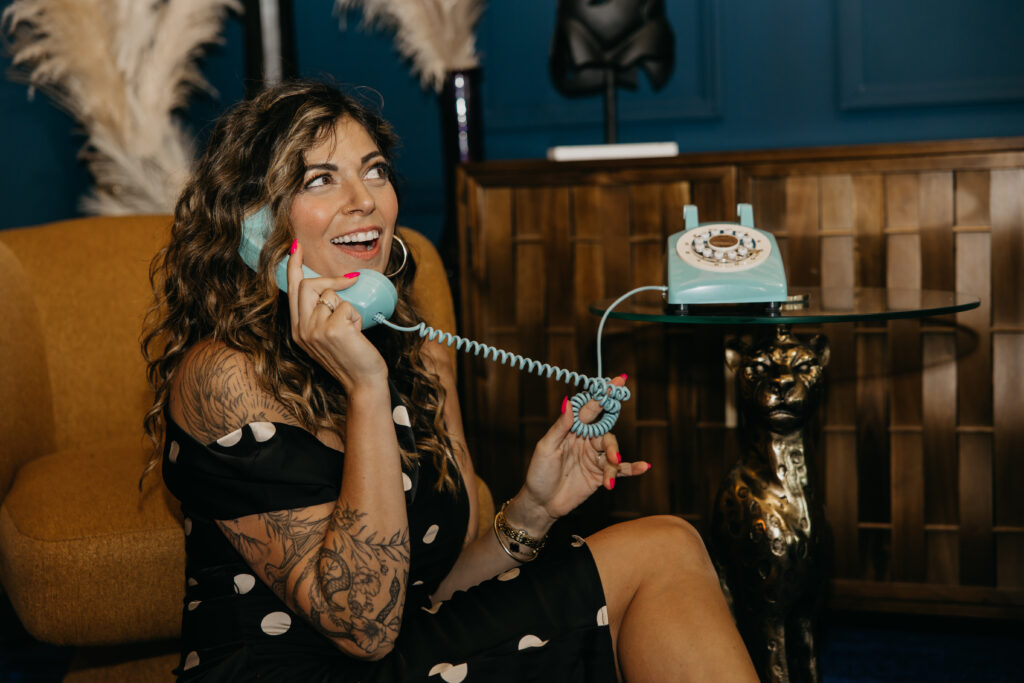 Candid photo of Dr. Lauryn laughing while eating fries and holding a Coke during her luxury brand session at Studio One Minneapolis.