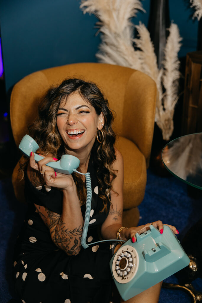 Candid photo of Dr. Lauryn laughing while eating fries and holding a Coke during her luxury brand session at Studio One Minneapolis.