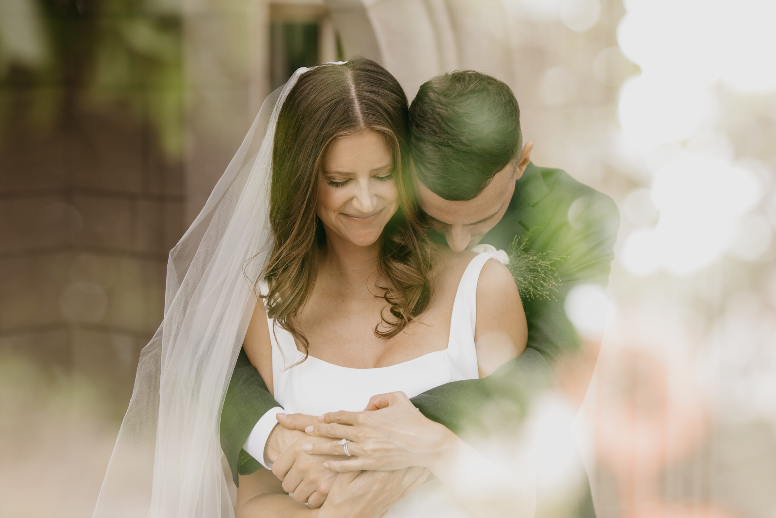Bride and groom embrace tenderly during their wedding at The Bakken Museum in Minneapolis, captured by Mycah Bain Photography.