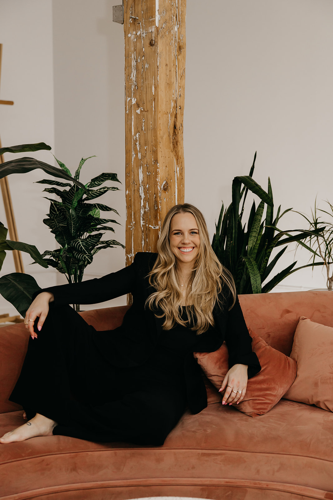 Minneapolis attorney Molly Hough Esq. seated on velvet couch during brand photography session with Mycah Bain Photography