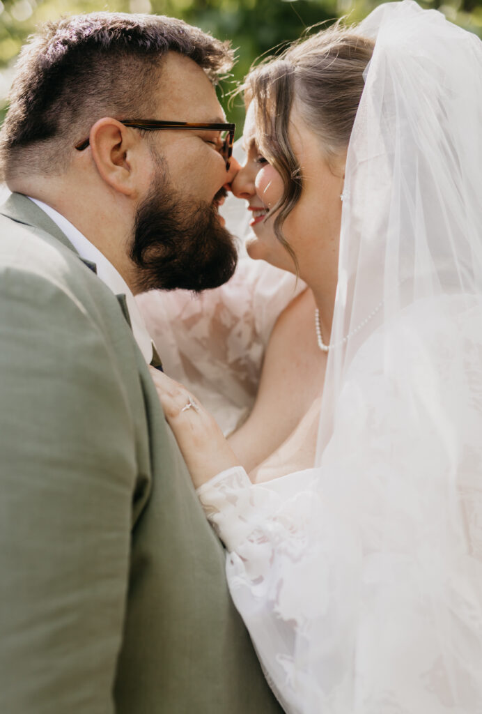 Bride and groom nose to nose under a flowing veil, intimate wedding portrait by Mycah Bain Photography