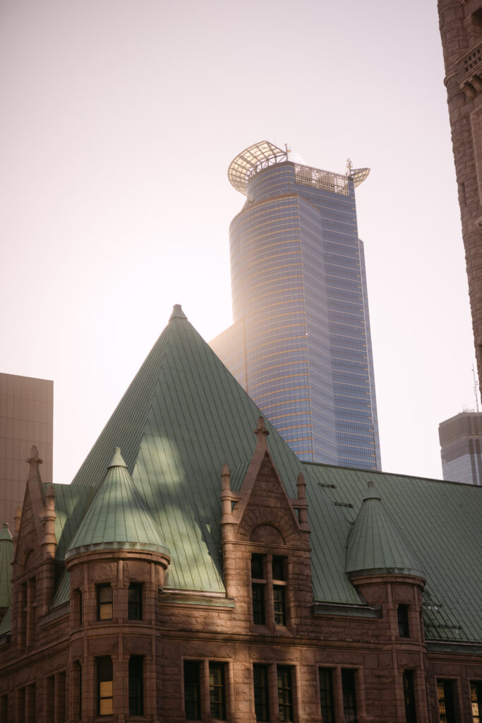 Downtown Minneapolis skyline with historic building rooftop and IDS Tower at dusk — exterior detail from MPR corporate event photography by Mycah Bain Photography