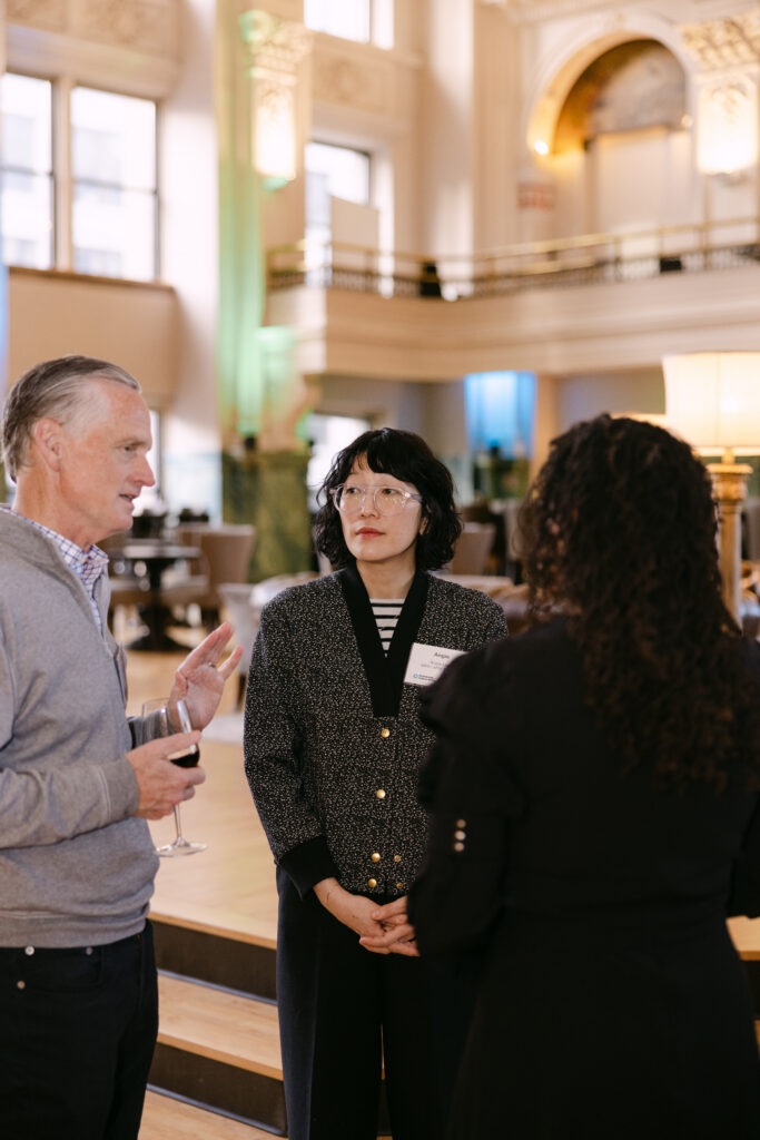 Minnesota Public Radio gala guests in conversation inside the grand atrium of the Minneapolis Grain Exchange — Minneapolis corporate event photographer