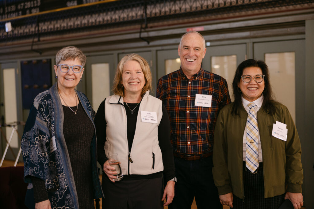 Two Minnesota Public Radio corporate event guests smiling for a photo inside the Minneapolis Grain Exchange — Mycah Bain Photography