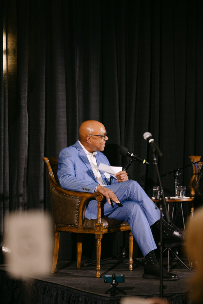 MPR speaker in blue suit presenting on stage at the Minneapolis Grain Exchange — Minneapolis corporate event photographer Mycah Bain Photography