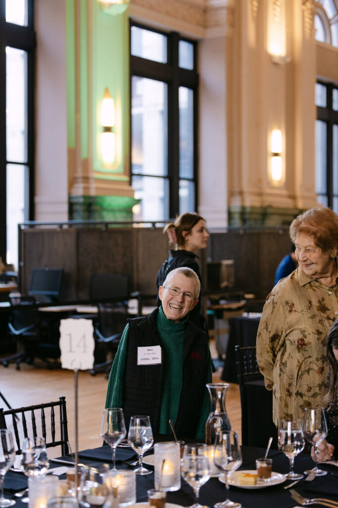 Minnesota Public Radio gala guests mingling at dinner tables inside the Minneapolis Grain Exchange — Minneapolis corporate event photographer Mycah Bain Photography