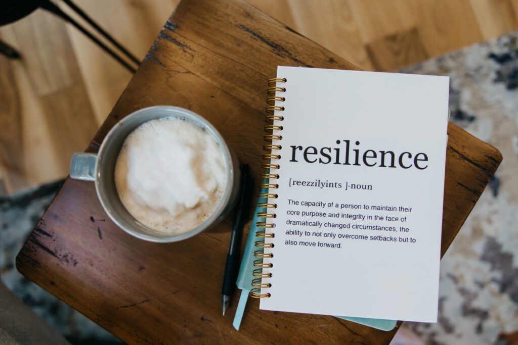 Resilience journal and latte on wooden table — B-roll detail from brand photography psychologist Minneapolis session