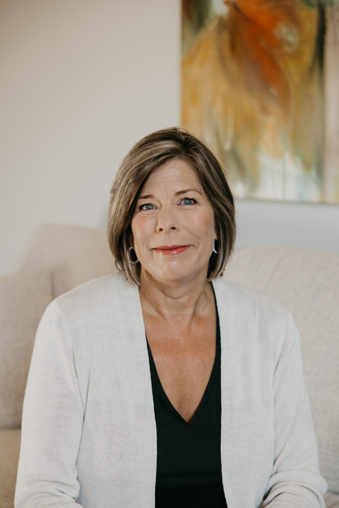 Dr. Melissa Polusny private practice psychologist portrait in cream cardigan during Minneapolis brand photography session by Mycah Bain Photography