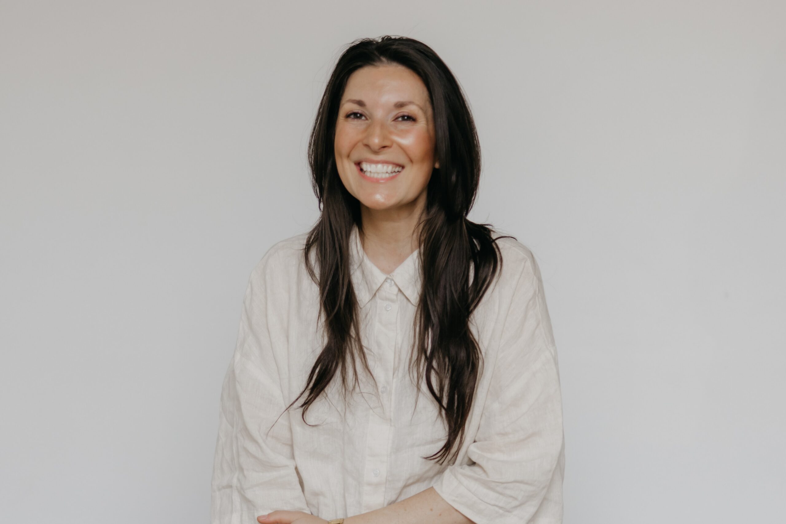 Minneapolis headshot photographer Mycah Bain Photography — Neu Neu North Loop team member professional headshot on light grey background