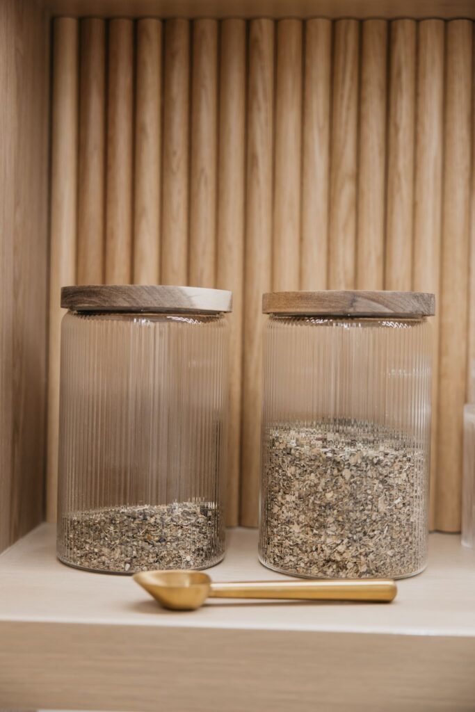 Glass herb jars on wooden shelf during MIMC clinic brand photography Minneapolis