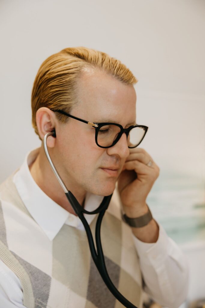 Male naturopathic doctor with stethoscope during integrative medicine brand photography session Minneapolis