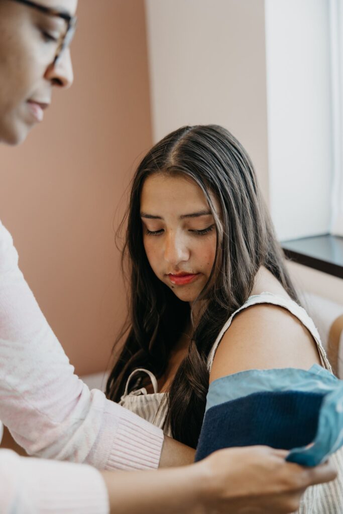 Provider checking patient blood pressure during healthcare brand photography session Minneapolis