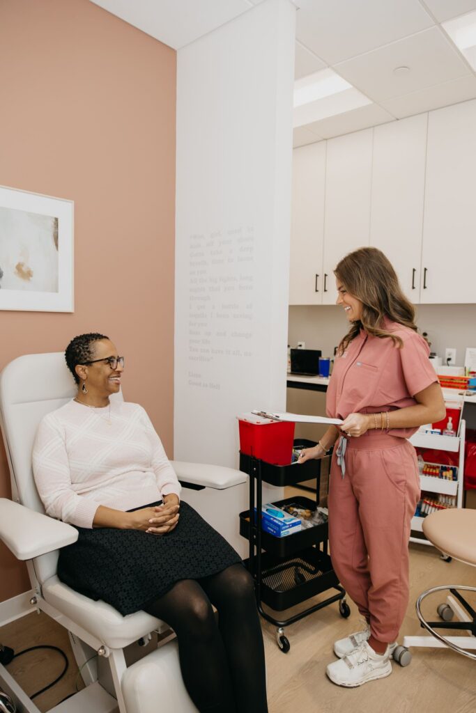MIMC provider consulting with smiling patient in infusion room during brand photography Minneapolis
