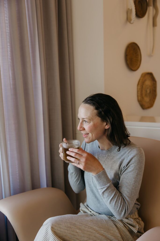 MIMC provider relaxed lifestyle portrait holding mug during healthcare brand photography Minneapolis
