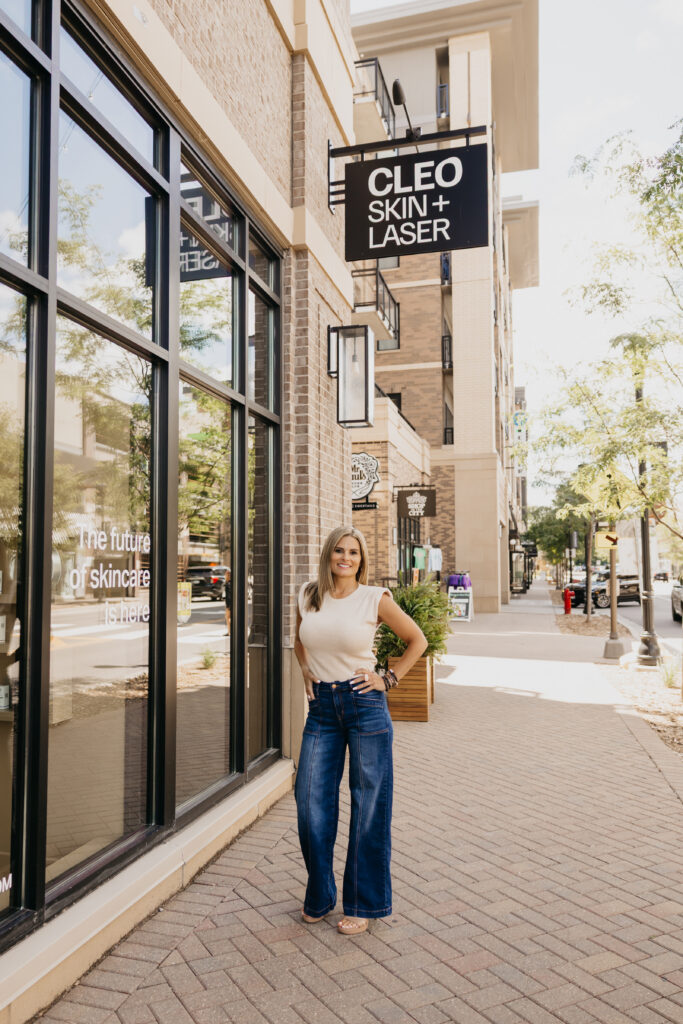 Woman standing outside the CLEO Skin + Laser storefront, Minneapolis med spa brand photography