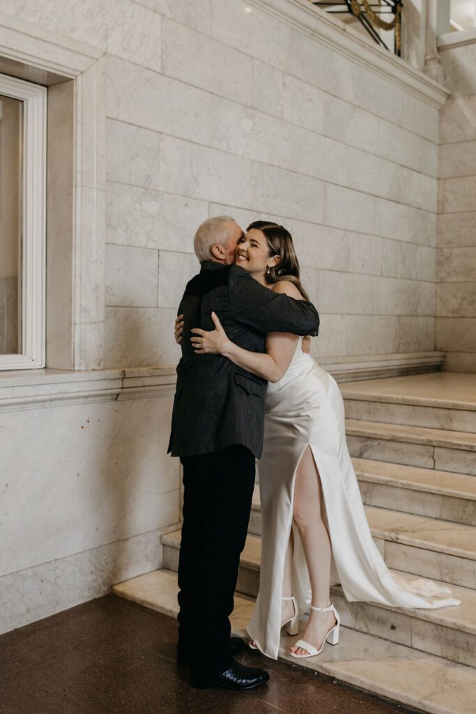 Bride embraces her father during their emotional first look moment