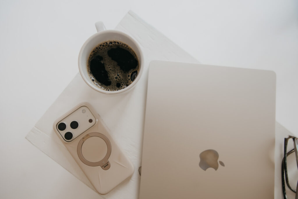 Flatlay of coffee mug, phone, and laptop styled for content creator brand photography