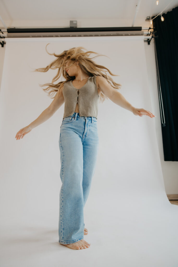 Content creator captured mid-movement with hair flying, candid brand photography moment