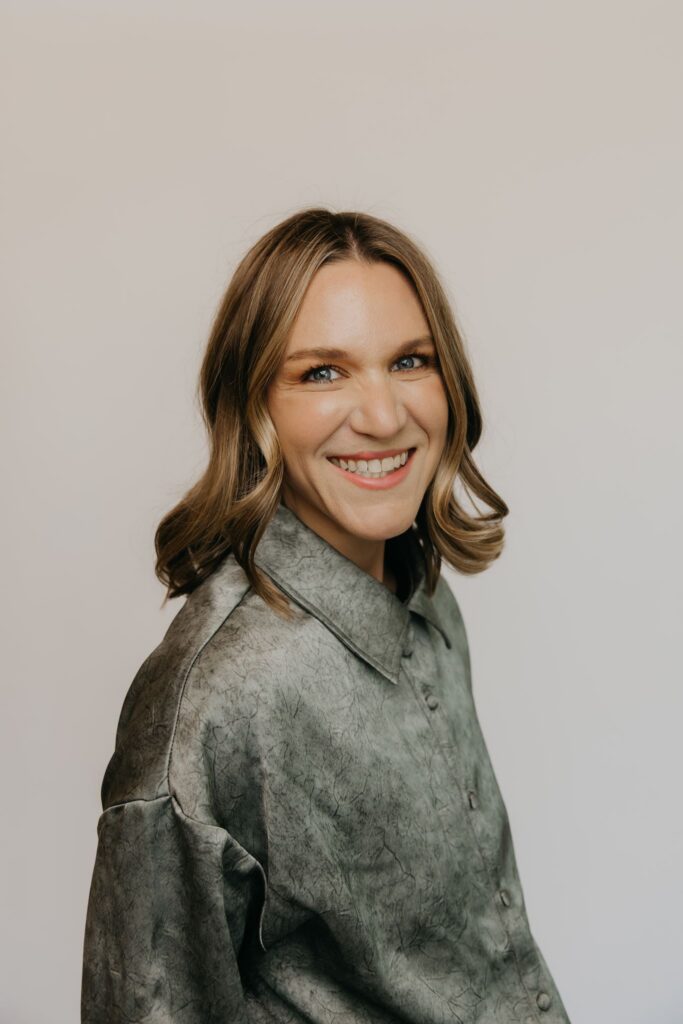 Integrative medicine team member smiling in olive green shirt, studio portrait