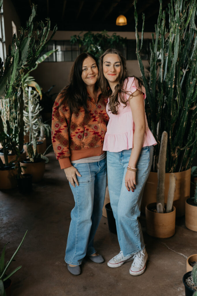 Minneapolis senior and her mom standing together among cacti during senior photography session with mom