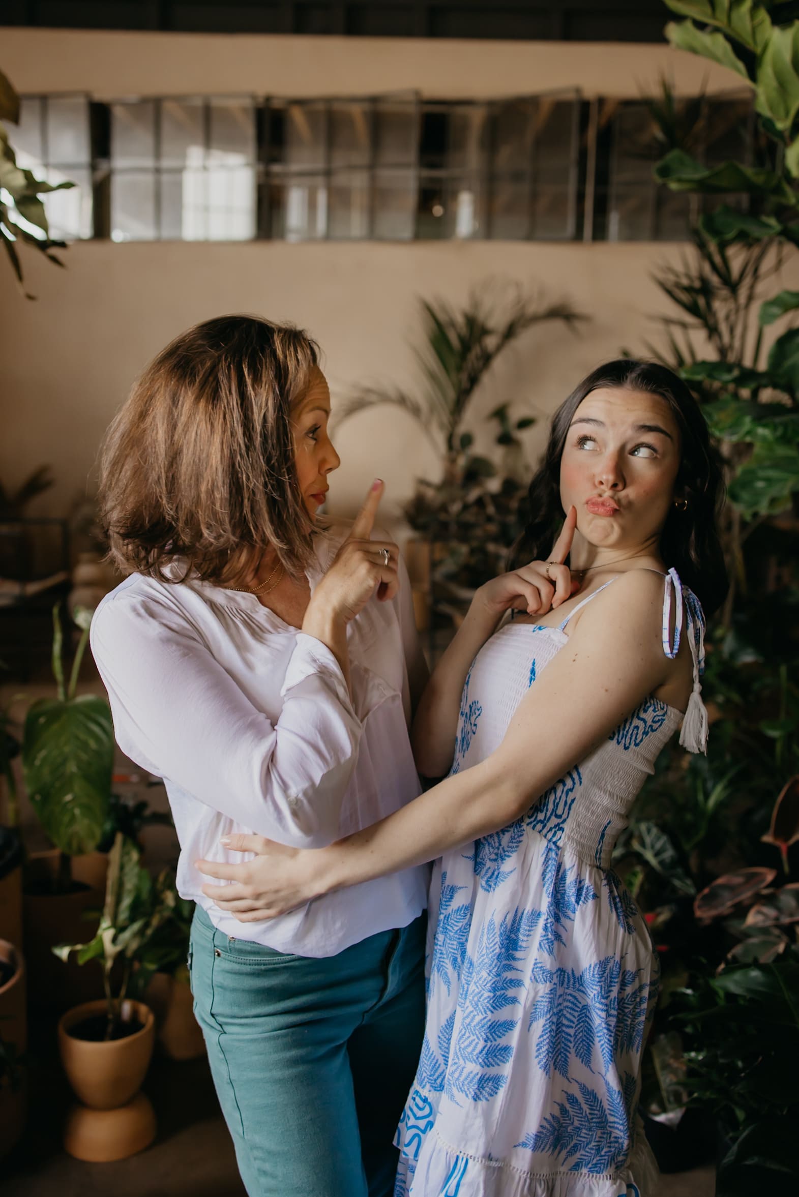 Minneapolis senior girl making a playful face at her mom during senior photography session with mom