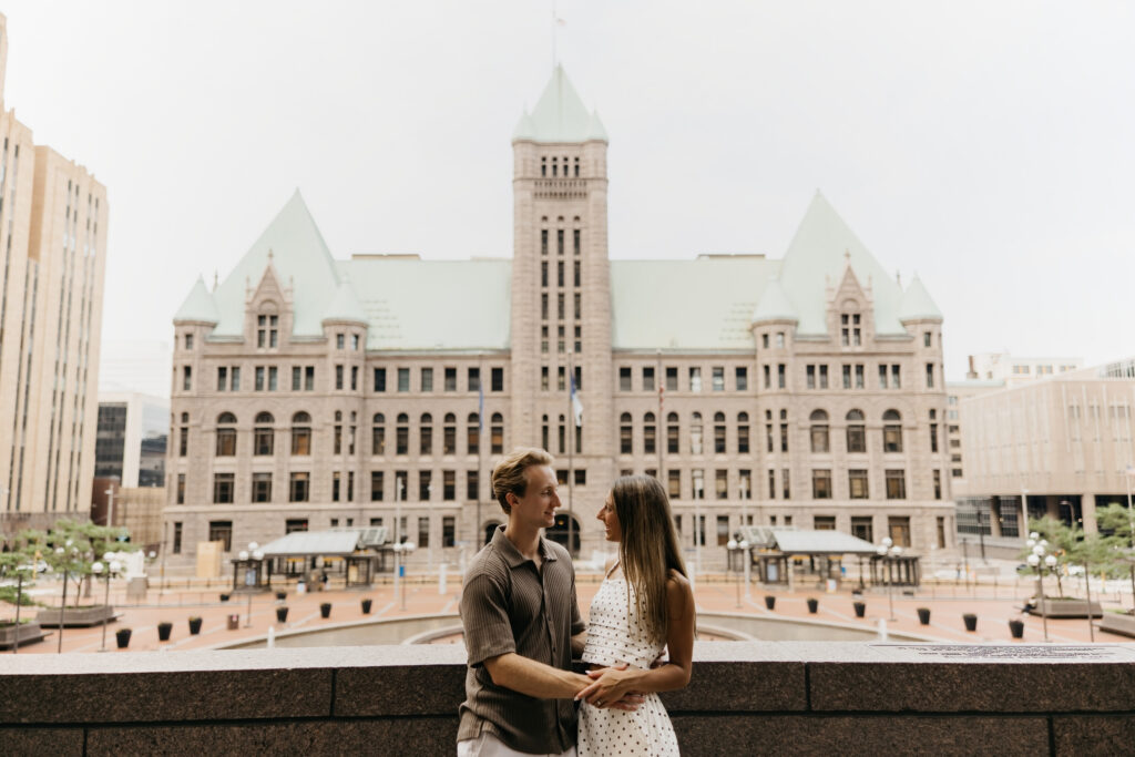 Couple standing together with a domed historic building visible behind them