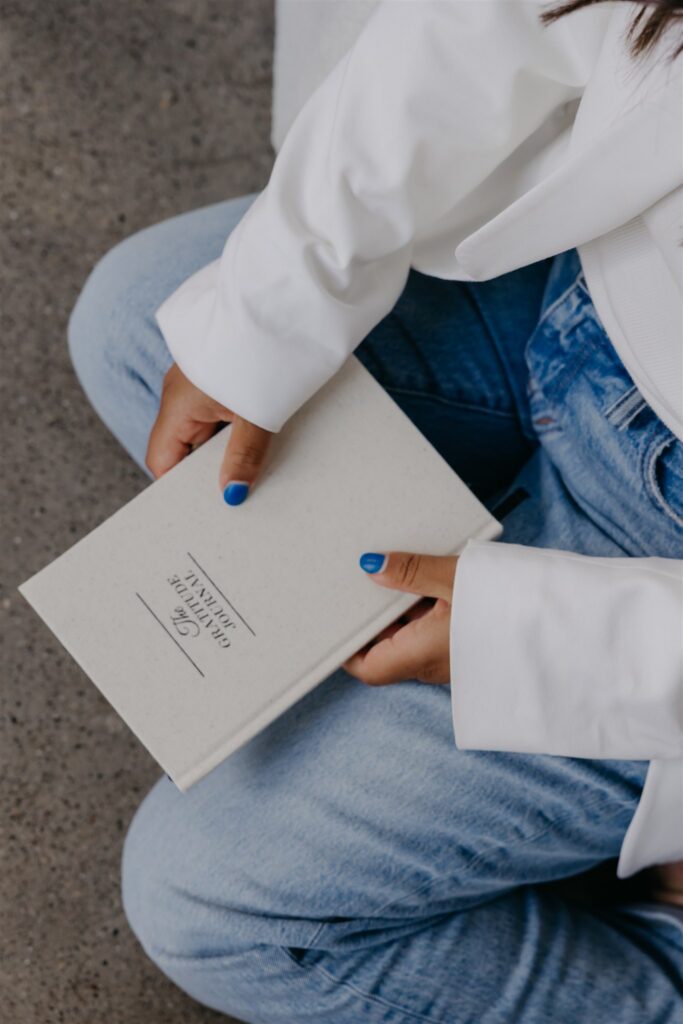 Close-up of hands holding a branded journal, product brand photography detail