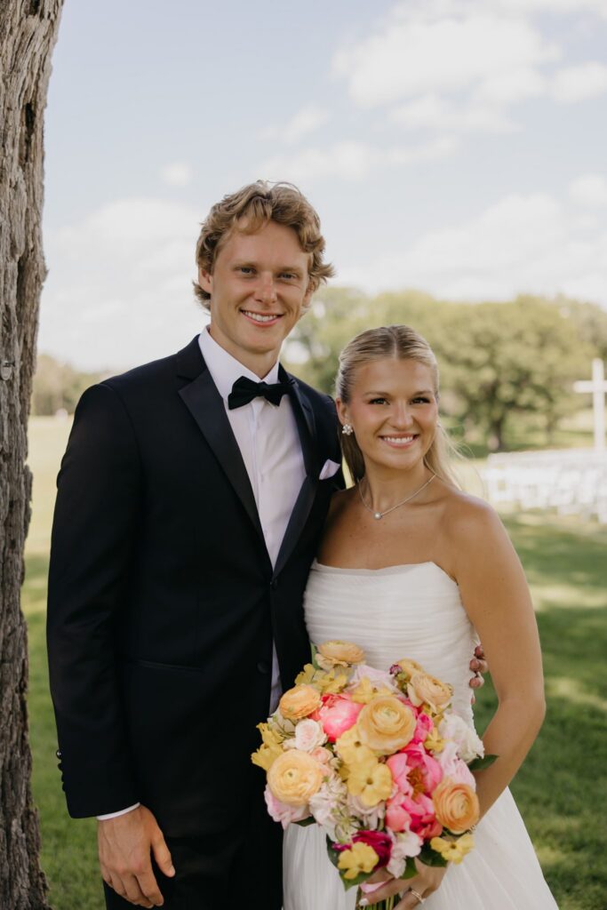 Groom and bride smiling close together on the lawn at Minneapolis Golf Club