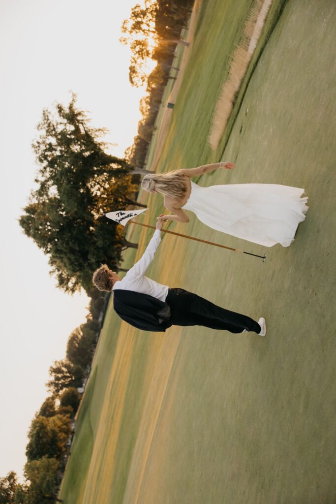 Bride and groom captured mid motion while walking on the fairway