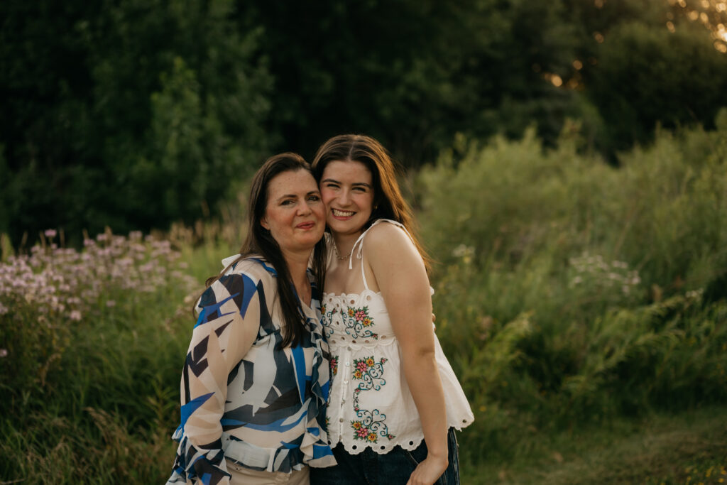 Emma Hollands and her mom smiling close together during her senior session