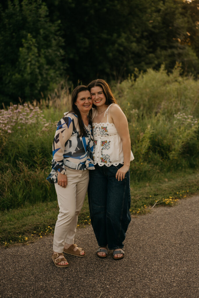 Emma Hollands and her mom standing together on a wooded path