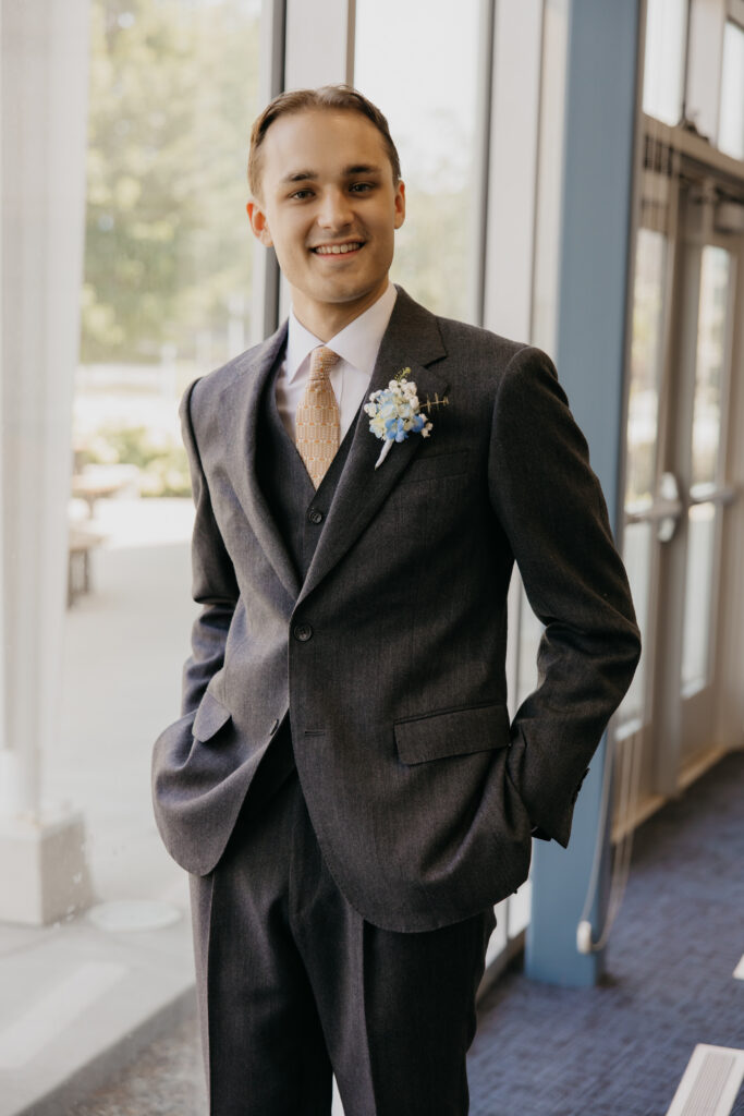 Groom smiles softly in a three-piece suit inside the American Swedish Institute before the ceremony