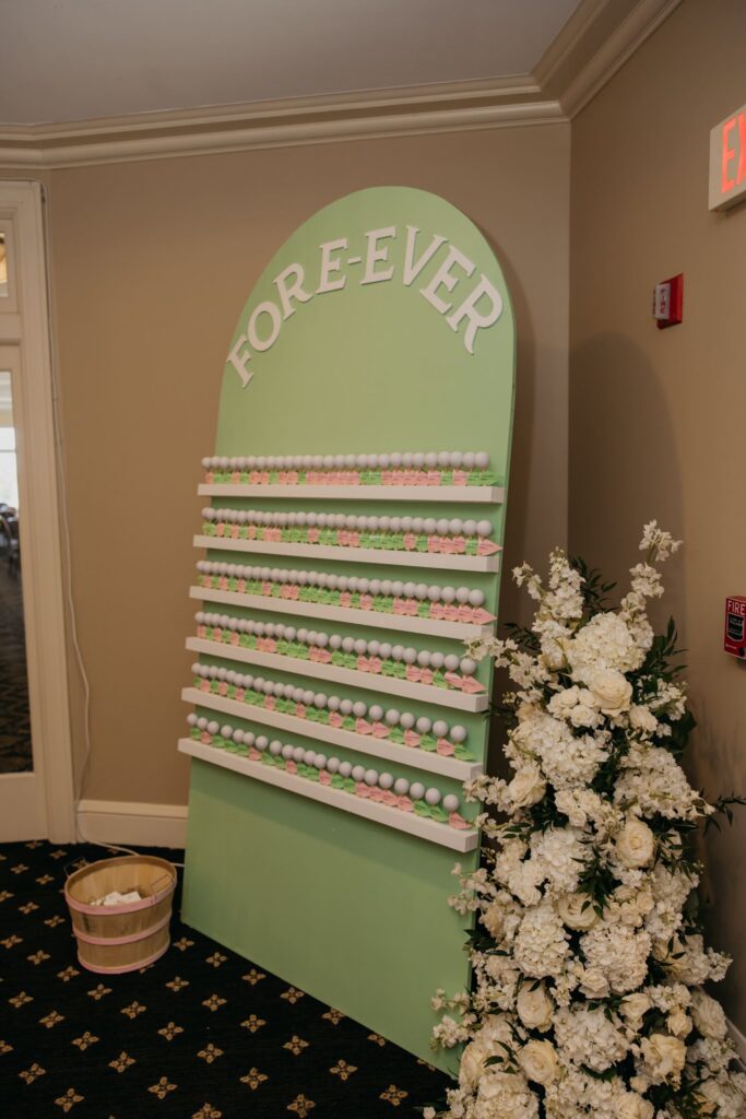 Mini golf themed "Fore-ever" dessert display surrounded by white florals
