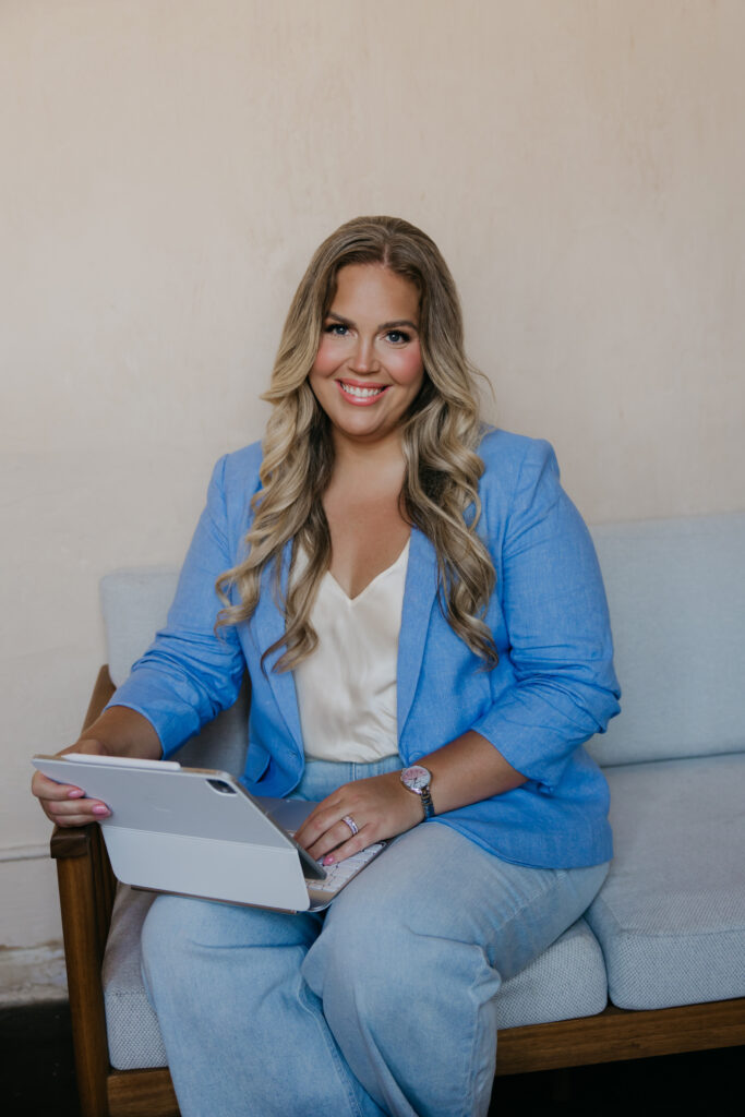 Caitlin Weseman on a light blue sofa with her tablet, a working astrologer brand photo