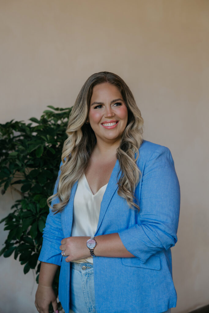 Caitlin Weseman posed at an angle in a blue blazer, brand photography for astrologers