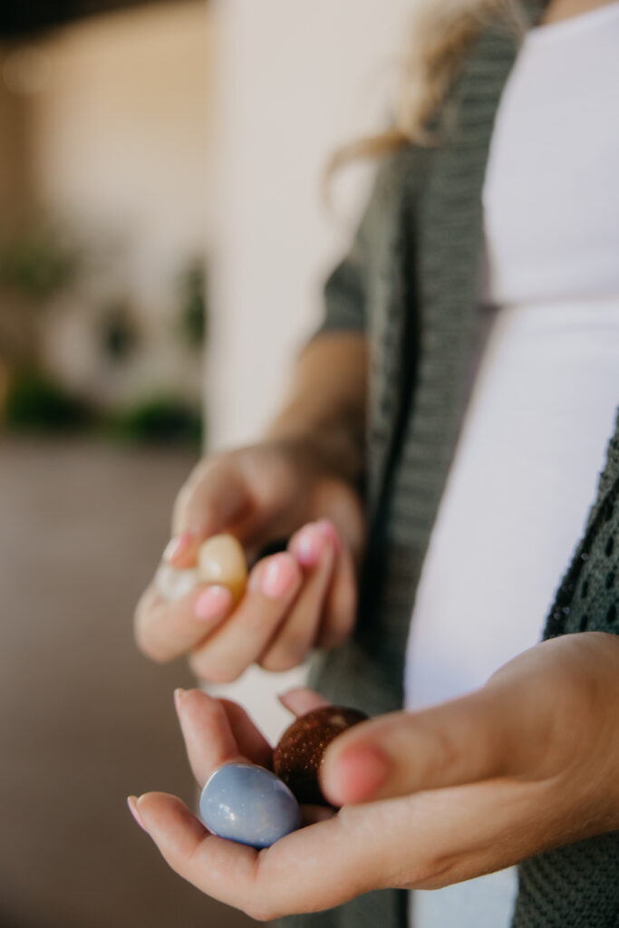Close-up of hands holding polished crystals, a spiritual business brand photography detail