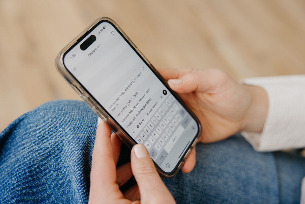 Close-up of hands typing a text message on a smartphone