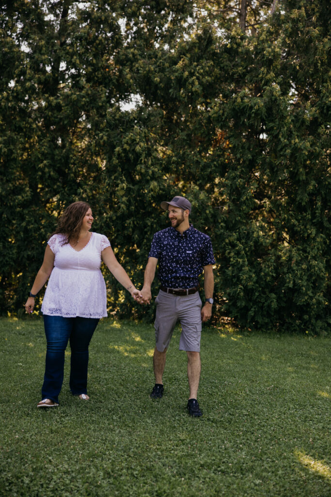 Couple walking hand in hand across the lawn during a family reunion photo session