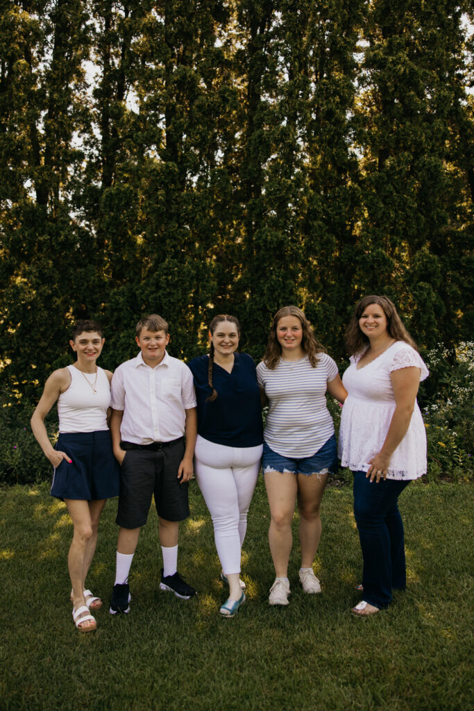 Siblings and cousins standing together for a group photo during a family reunion session
