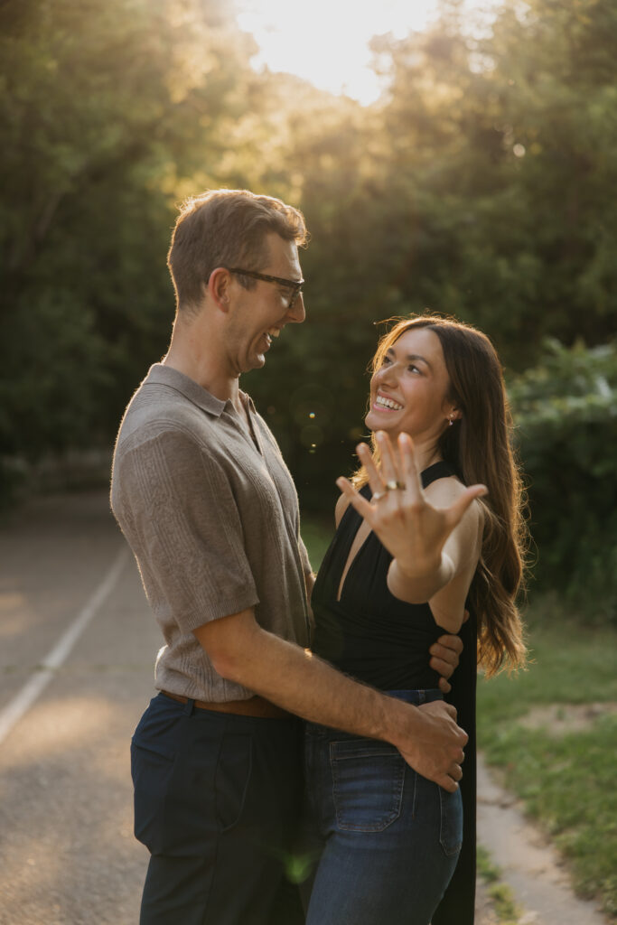 Newly engaged couple laughing together right after the proposal moment in Minneapolis